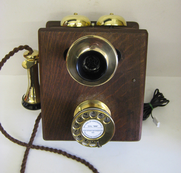 Original wood wall phone with new brass fittings. Original wood wall phone with new brass fittings.